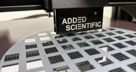 Close-up of the Jetforge printhead assembly during a deposition test. Photo via Added Scientific.