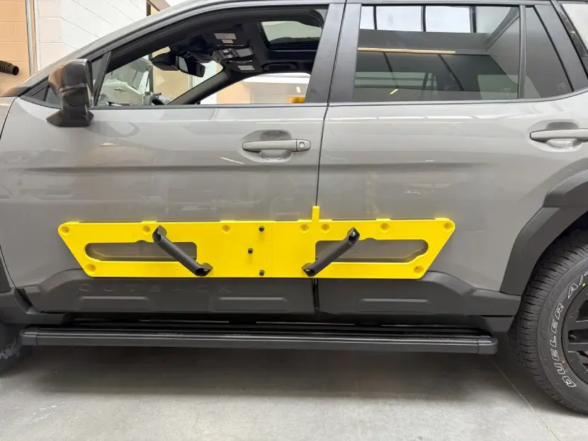 Subaru engineer positioning a 3D printed installation fixture. Photo via Stratasys.