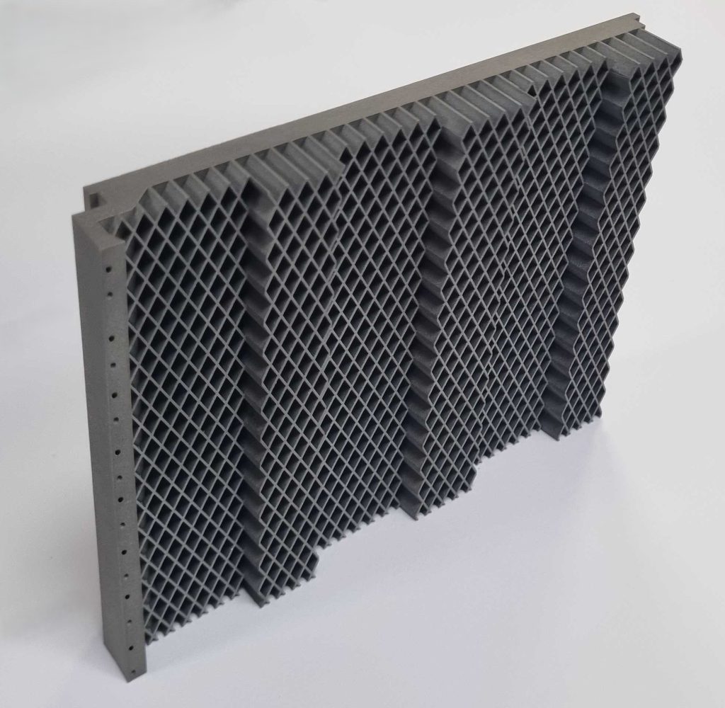 3D printed honeycomb tile created using ABD-1000AM. Photo via Alloyed Ltd.