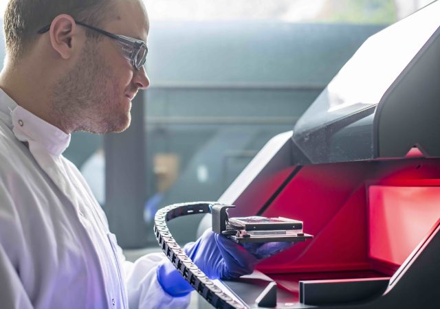 Dr. Robert Owen working with laboratory equipment. Photo via University of Nottingham.
